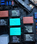 Close-up view of Omron G8HL-H71 relays in a vehicle fuse box, compatible with Honda/Acura models, made in USA.