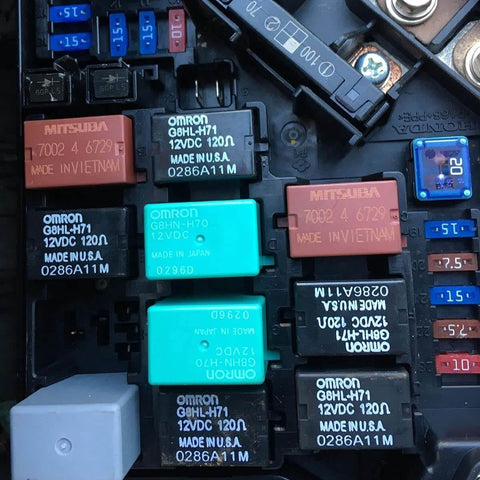 Close-up view of Omron G8HL-H71 relays in a vehicle fuse box, compatible with Honda/Acura models, made in USA.