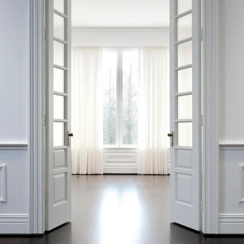 Spacious room with white French doors leading to a bright window view, highlighting interior use for 3.5 inch stainless steel door hinges.