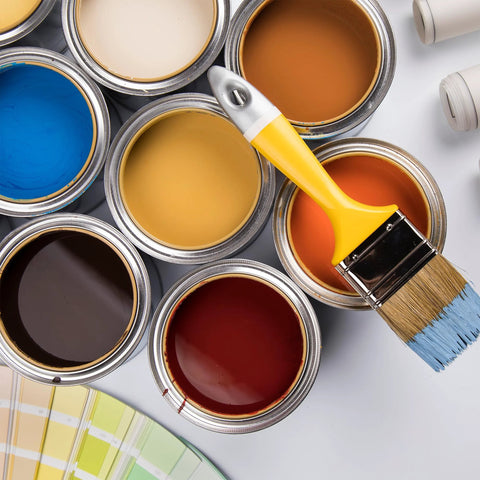 Open paint cans with various colors and a paintbrush on top, including blue, brown, yellow, and red paint.