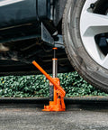 6 Ton Hydraulic Bottle Jack For Cars Trucks SUVs With 7.7 To 14.8 Inch Lifting Range Heavy Duty Welded Body Orange Built To Handle Auto Repair Farm Work And Home Lifts Ready To Roll lifting a car
