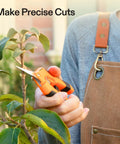 Person using 6.5 Inch Gardening Scissors Hand Pruner Pruning Shear With Straight Stainless Steel Blades Orange 1 Pack on plant