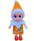 Toy doll wearing orange hat and dress with tree design, red shoes, and white collar, standing on a white surface.