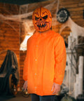 Person wearing Orange Disposable Lab Jackets For Adults Large Pack Of 30 Pro Grade Polypropylene Medical Coats with Halloween mask in a themed room