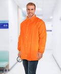 Man wearing an orange disposable lab jacket with elastic wrists, snap front, and collar in a medical setting.
