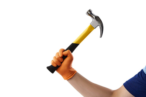 Person wearing Hi-Visibility Orange Nitrile Gloves 8 Mil Thick Diamond Texture Grip 50 Count holding a hammer.