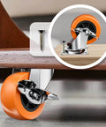 Close-up of 2 Inch Casters With Side Brake Set Of 8 Orange Polyurethane Swivel Plate Wheels installed on workbench, with screw detail.
