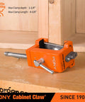 Close-up of 2 Pack Pony 8510 Cabinet Claw Face Frame Clamp in orange on wooden surface.
