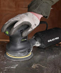 280W Orbital Sander 13000 RPM With Dust Collection And 15 Discs in use on a metal surface, attached dust bag visible