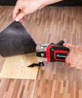 3.5 Amp Oscillating Multi Tool with 4.5 Degree Oscillation cutting wood flooring, showing 6 variable speeds and auxiliary handle.