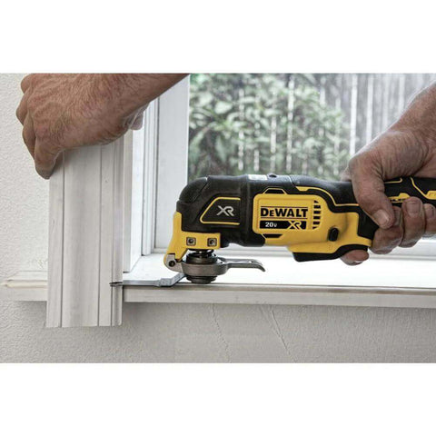 Person using 20V Max XR Oscillating Tool Kit With Blades And Charger Included on window trim