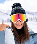 Woman wearing OTG Ski Goggles With Anti Fog Lenses And UV Protection Dual Venting Red White, smiling on snowy slope.