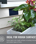 Extreme Outdoor Double Sided Mounting Tape Built To Handle Up To 15 Pounds On Brick Or Rough Surfaces UV And Weather Resistant 14 Ft Roll installed on a wall with a planter box.