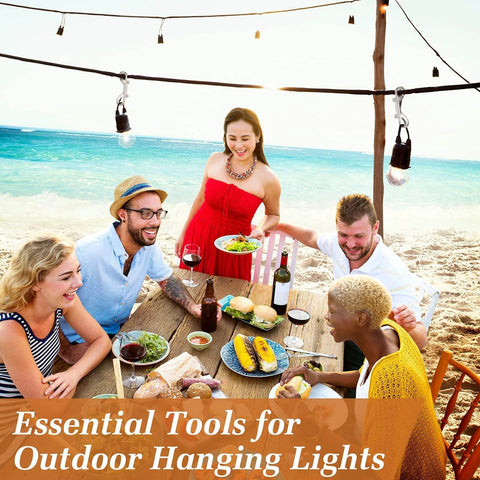 Group of friends dining at a beach table with drinks and food, under hanging outdoor lights, enjoying a cheerful gathering.
