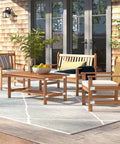 Wooden outdoor patio furniture set with chairs, bench, and table on a deck with shingles and glass doors in the background.