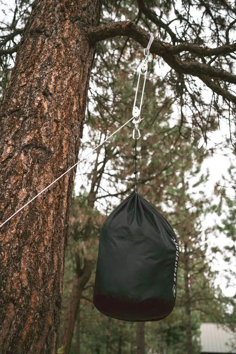 Heavy Duty Indoor Outdoor Pulley Hoist With Chromed Pulleys Polypropylene Rope 440 Lb Capacity 65 Ft suspending a bag from a tree
