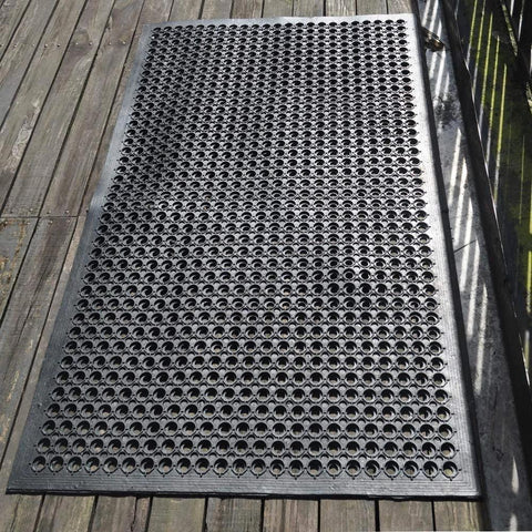 Outdoor Rubber Floor Mat With Drainage Holes Anti Slip Heavy Duty Entrance Mat for wet areas, shown outdoors on wood deck.