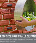 Extreme Outdoor Double Sided Mounting Tape Built To Handle Up To 15 Pounds On Brick Or Rough Surfaces UV And Weather Resistant 14 Ft Roll applied on brick wall supporting metal planter