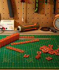 Outlet Spacers Set 60 Pieces For Electrical Box Extender Plastic Shims on green cutting mat with tools in workshop.