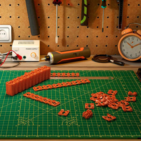 Outlet Spacers Set 60 Pieces For Electrical Box Extender Plastic Shims on green cutting mat with tools in workshop.