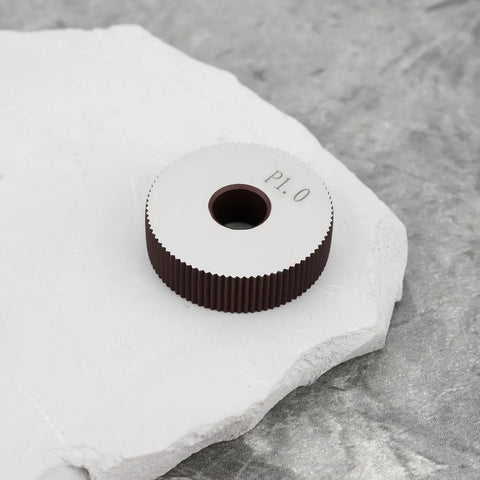 Two Pieces P1.0mm Straight Knurling Wheels, 28x8x8mm Steel Roller on stone surface
