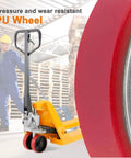 Pallet truck with red PU tread wheels in warehouse, highlighting pressure resistance of pallet jack full wheel set assembled.