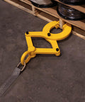 Beefy Heavy Duty Pallet Puller Clamp With 6000 Lb Capacity attached to pallet with strap on warehouse floor