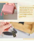 Close-up of pink wallet with pink paracord zipper pull and hand holding keys with green paracord zipper pull.