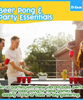 Friends playing beer pong outdoors with multi color ping pong balls, enjoying party with drinks and games, highlighting social gathering.