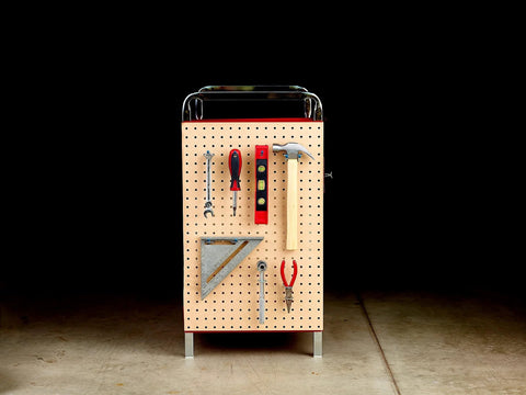 Pegboard tool organizer with assorted tools including pliers, hammer, and screwdriver displayed in a garage setting.