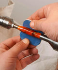 Hands using pen sanding kit with soft touch pads 1500 to 12000 grit for finishing on a pen blank lathe