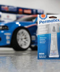 Permatex 80345 White Lithium Grease, 1.5 oz in packaging with blue car in background