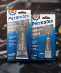 Permatex 81150 Dielectric Tune-Up Grease, 0.33 oz. Tube, Silver packaging front view with automotive background