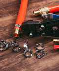 Three Quarters Inch PEX Cinch Clamp Rings in Premium 304 Stainless Steel Thickened Design for 360 Degree Watertight Seals displayed on wooden surface