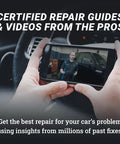 Person viewing car repair video on smartphone inside vehicle.