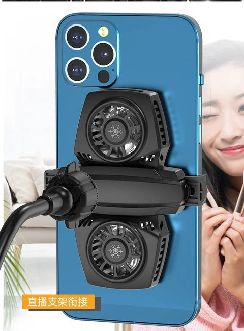 Smartphone with cooling fans attached to the back, smiling person in the background, visible mount adapter.