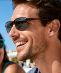 Man smiling while wearing Photochromic Polarized Driving Sunglasses for Men Day and Night Vision outdoors