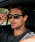 Man adjusting Photochromic Polarized Driving Sunglasses for Men Day and Night Vision while sitting in a car