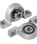 Two Six Pack KP000 10mm Pillow Block Bearing Self Aligning Mounted Flanges made of zinc alloy for machinery conveying systems, close-up view.