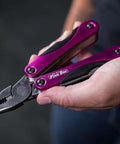 Close-up of a Pink 14-In-1 Aluminum Multi-Tool with stainless steel pliers, compact for DIY, home, camping, and everyday carry.