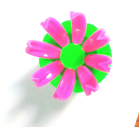 Top view of a pink and green multicolor dumpling mold set for momos baozi and steam buns, plastic kitchen tool.