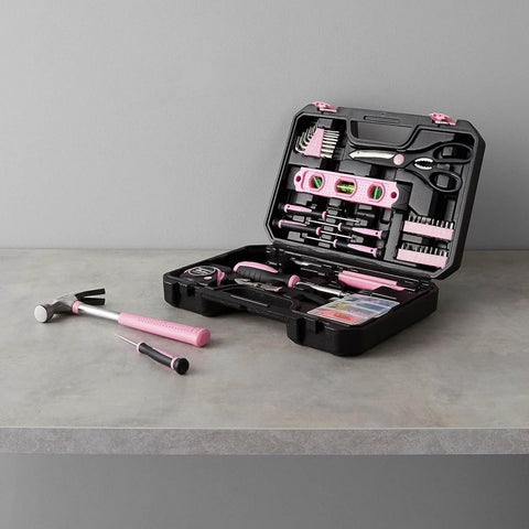 Open pink 142-piece household tool kit with storage case, showing tools for home repairs and DIY projects on a grey surface.