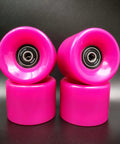 Pink 60mm skateboard wheels with bearings set of 4 92a hardness ideal for street and park, shown stacked on black surface