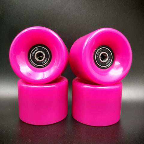 Pink 60mm skateboard wheels with bearings set of 4 92a hardness ideal for street and park, shown stacked on black surface