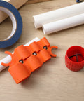 Six In One Depth Gauge And Pipe Deburring Tool Kit with orange gauge and red deburring tool on wooden surface