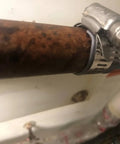 Close-up view of a rusty pipe with a stainless steel clamp from Pipe Leak Repair Kit With 6 Patches And Stainless Steel Clamps, No Water Shut Off Needed.