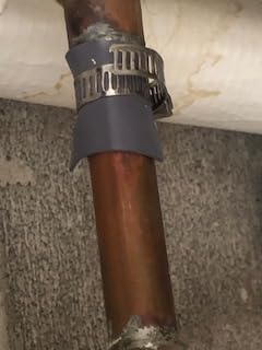 Pipe Leak Repair Kit With 6 Patches And Stainless Steel Clamps on copper pipe, no water shut off needed, flexible rubber patch shown in use.