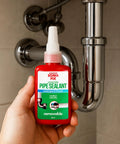 Hand holding Pipe Thread Sealant For Metal Pipes And Threaded Fittings With Anaerobic Cure Medium Viscosity For High Pressure, near pipes