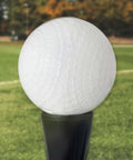 MLB Plastic Baseballs - 8 Pack shown on a stand in a grassy field, highlighting perforated design for safe training.