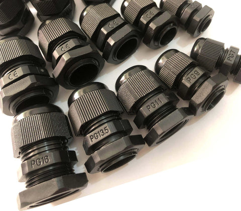 Assorted black cable gland connectors arranged on a white surface.
